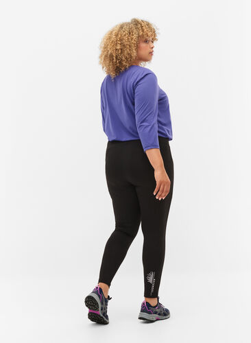 Sports tights with reflective details and side pocket, Black, Model image number 1