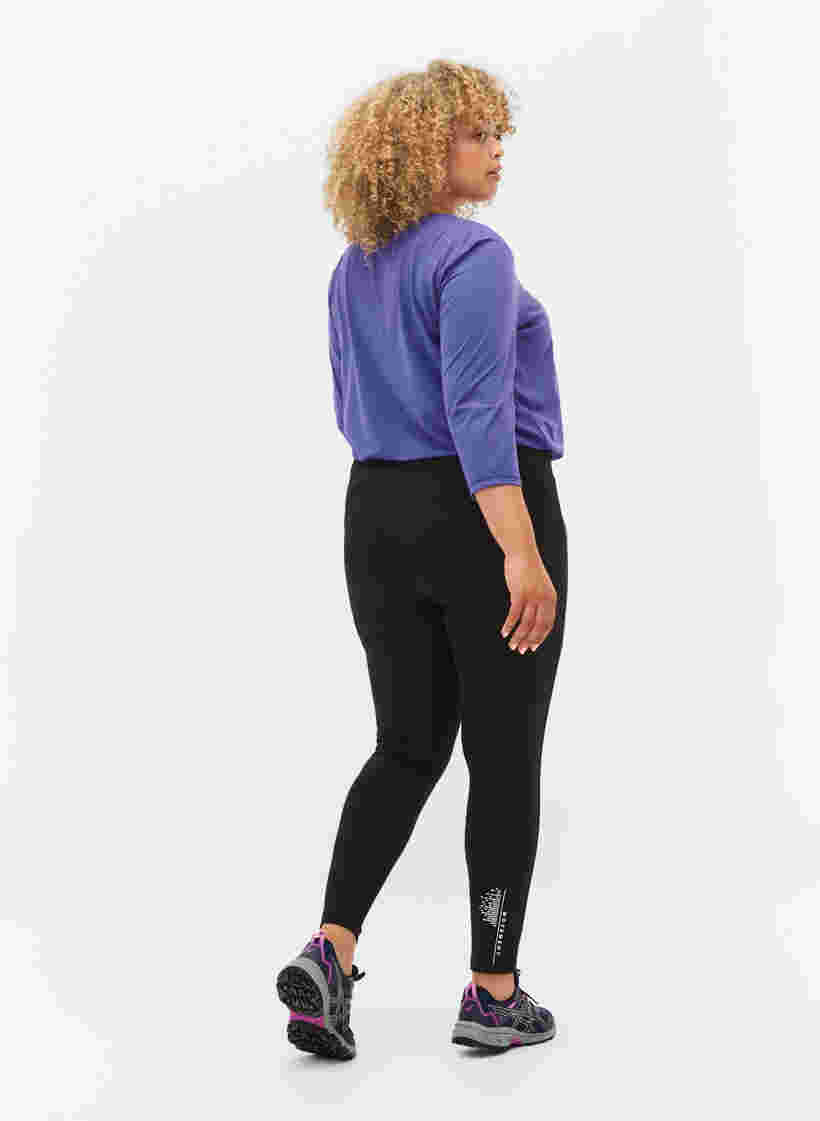 Sports tights with reflective details and side pocket, Black, Model image number 1
