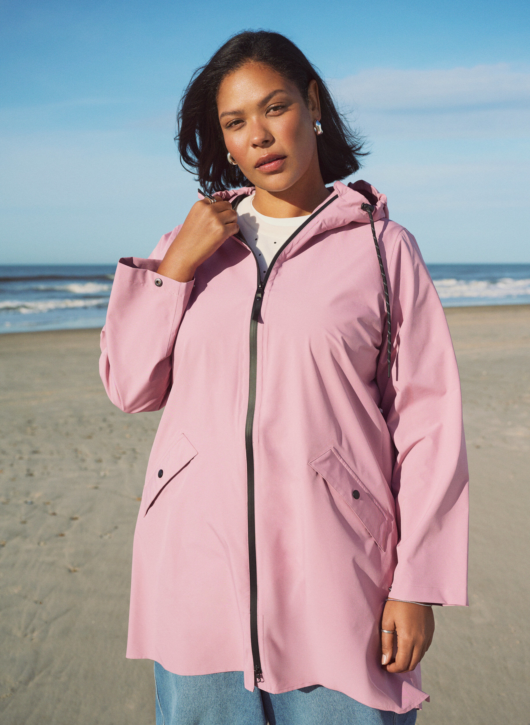 Rain jacket with pockets and a hood