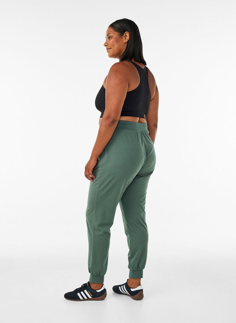 Loose workout trousers with pockets, Green, Model image number 1