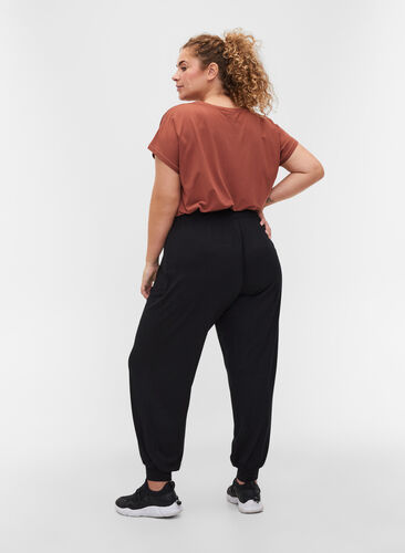 Loose, viscose sports trousers, Black, Model image number 1