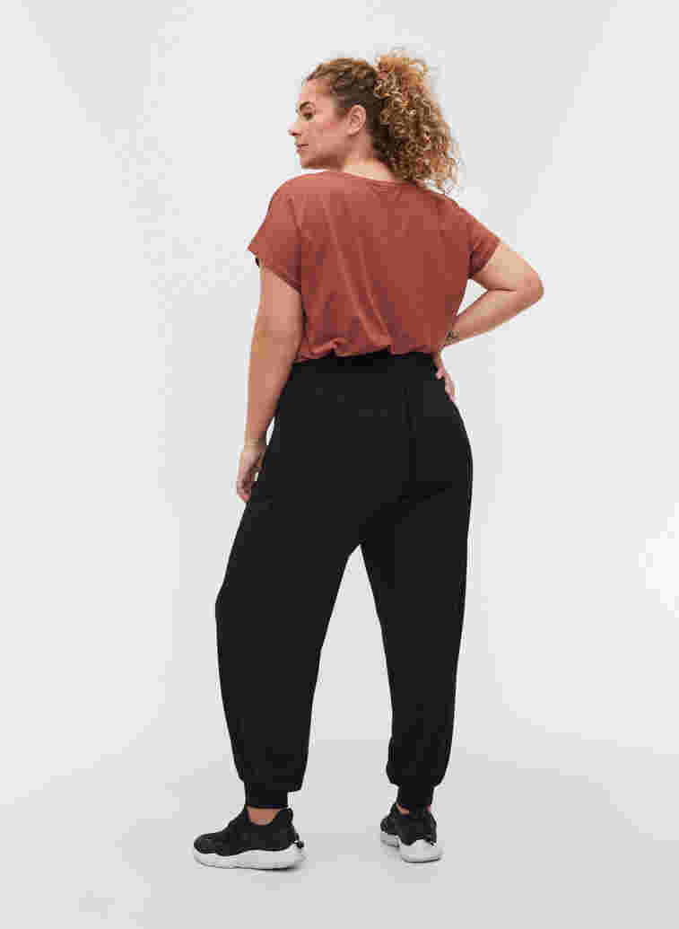 Loose, viscose sports trousers, Black, Model image number 1