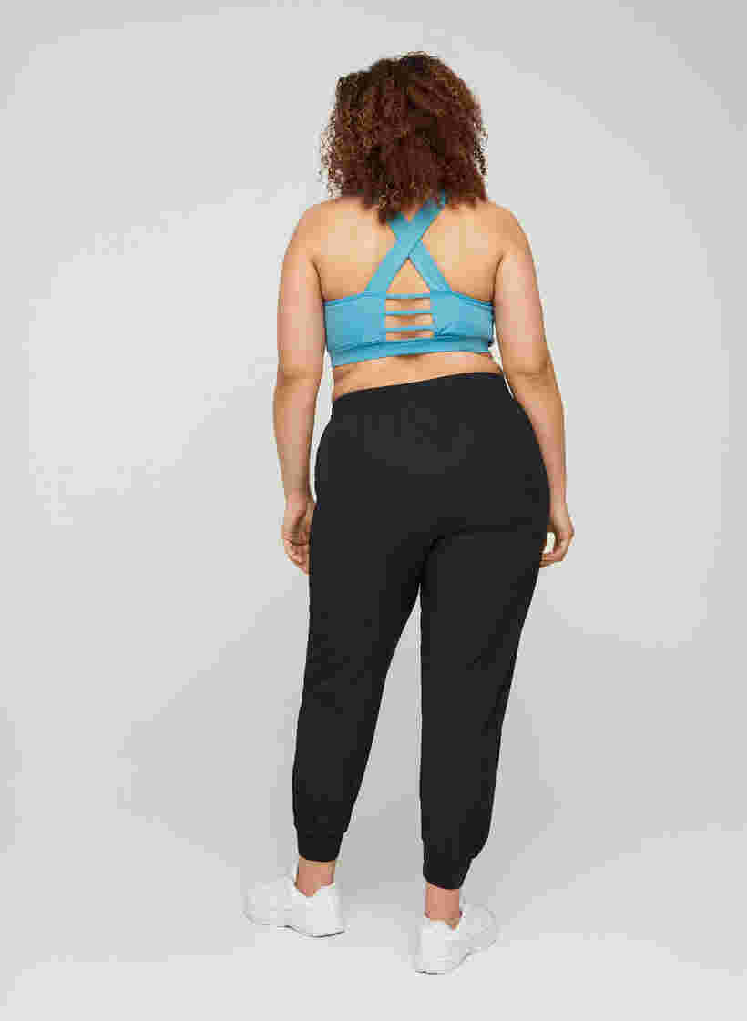 Loose exercise trousers with pockets, Black, Model image number 1