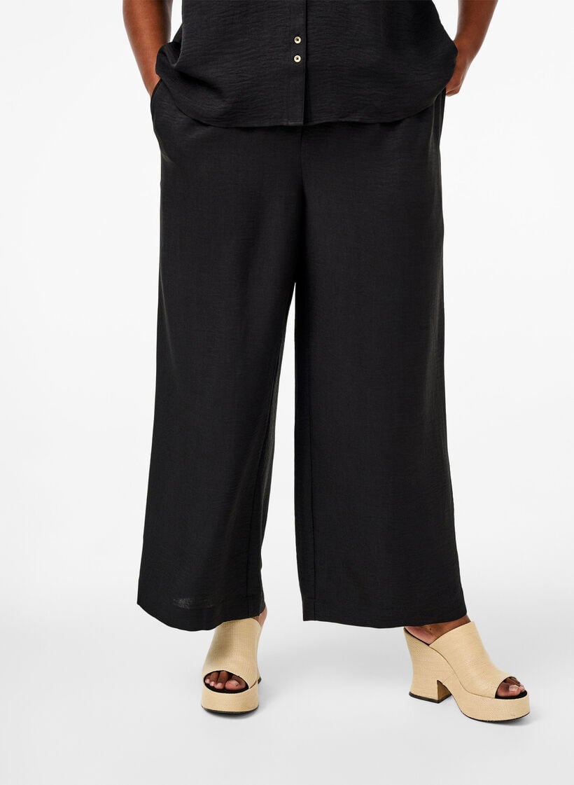 Loose trousers with elasticated waistband and pockets, Black, Model image number 2