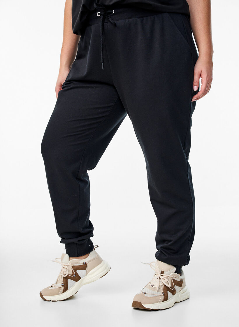 Loose tracksuit trousers with pockets, Black, Model image number 0