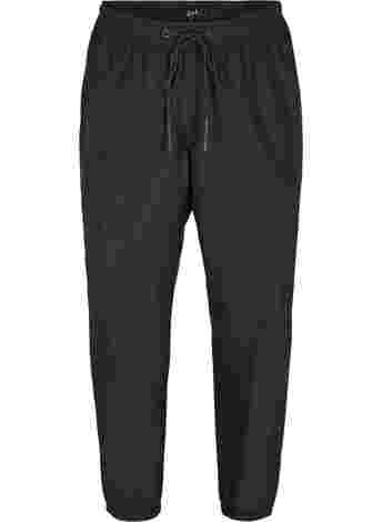 Rain trousers with elastic and drawstrings