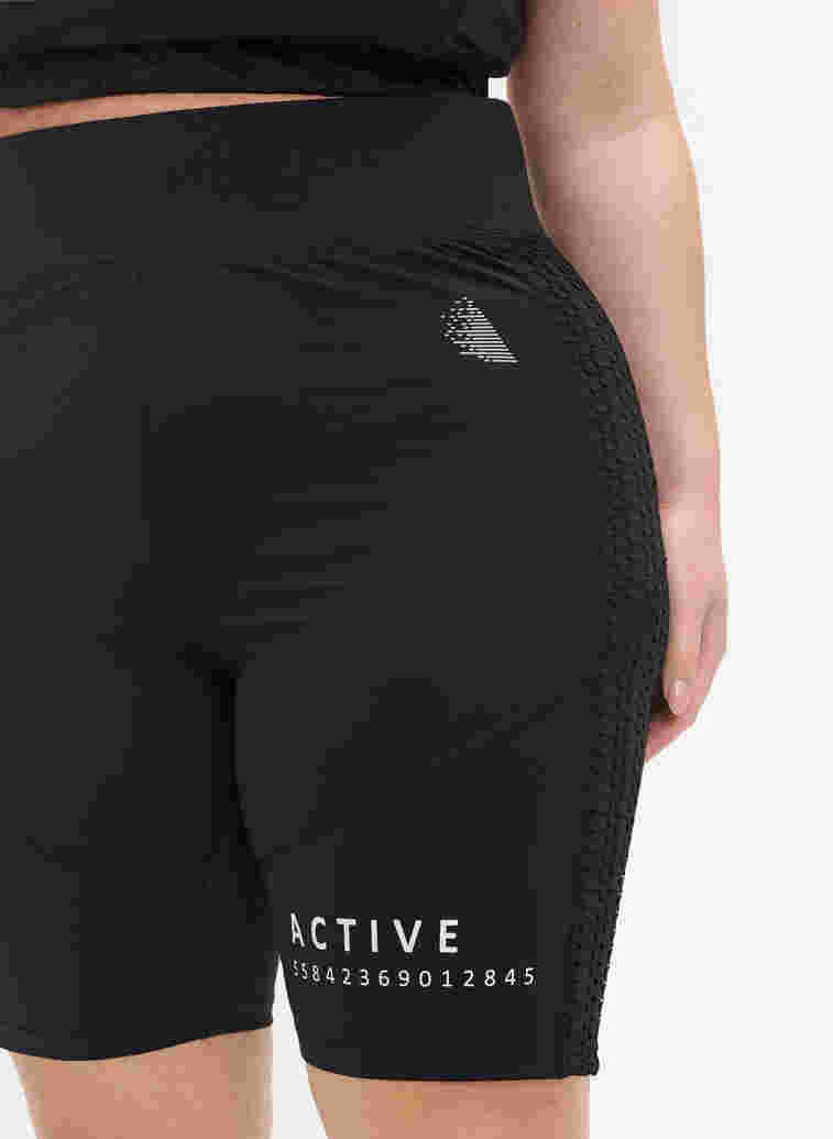 Close-fitting sports shorts with text print, Black, Model image number 1
