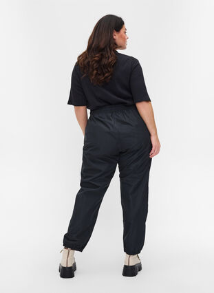 Rain trousers with elastic and drawstrings, Black, Model image number 1