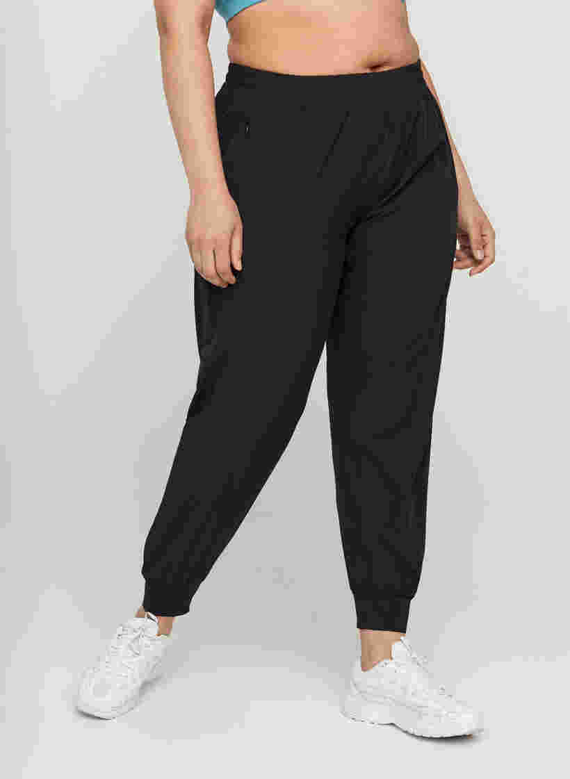 Loose exercise trousers with pockets, Black, Model image number 0