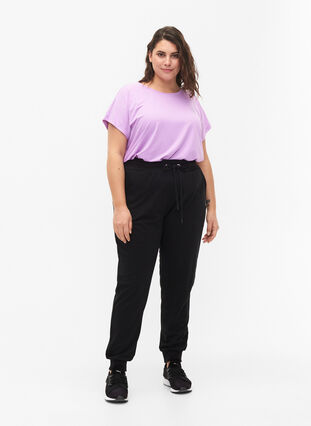 Loose workout trousers with pockets, Black, Model image number 3