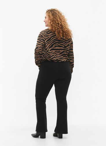 Flared trousers with slits in front, Black, Model image number 1