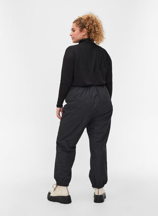 Reflective rain trousers, Black, Model image number 1