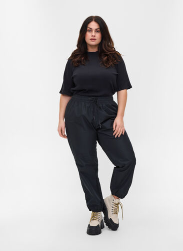 Rain trousers with elastic and drawstrings, Black, Model image number 0