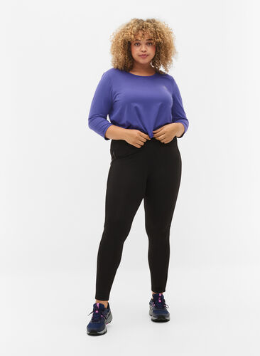 Sports tights with reflective details and side pocket, Black, Model image number 0