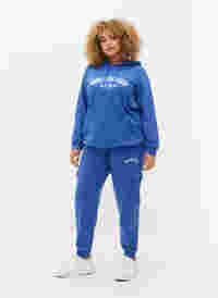 Sweatpants with cargo pockets, Dazzling Blue, Model