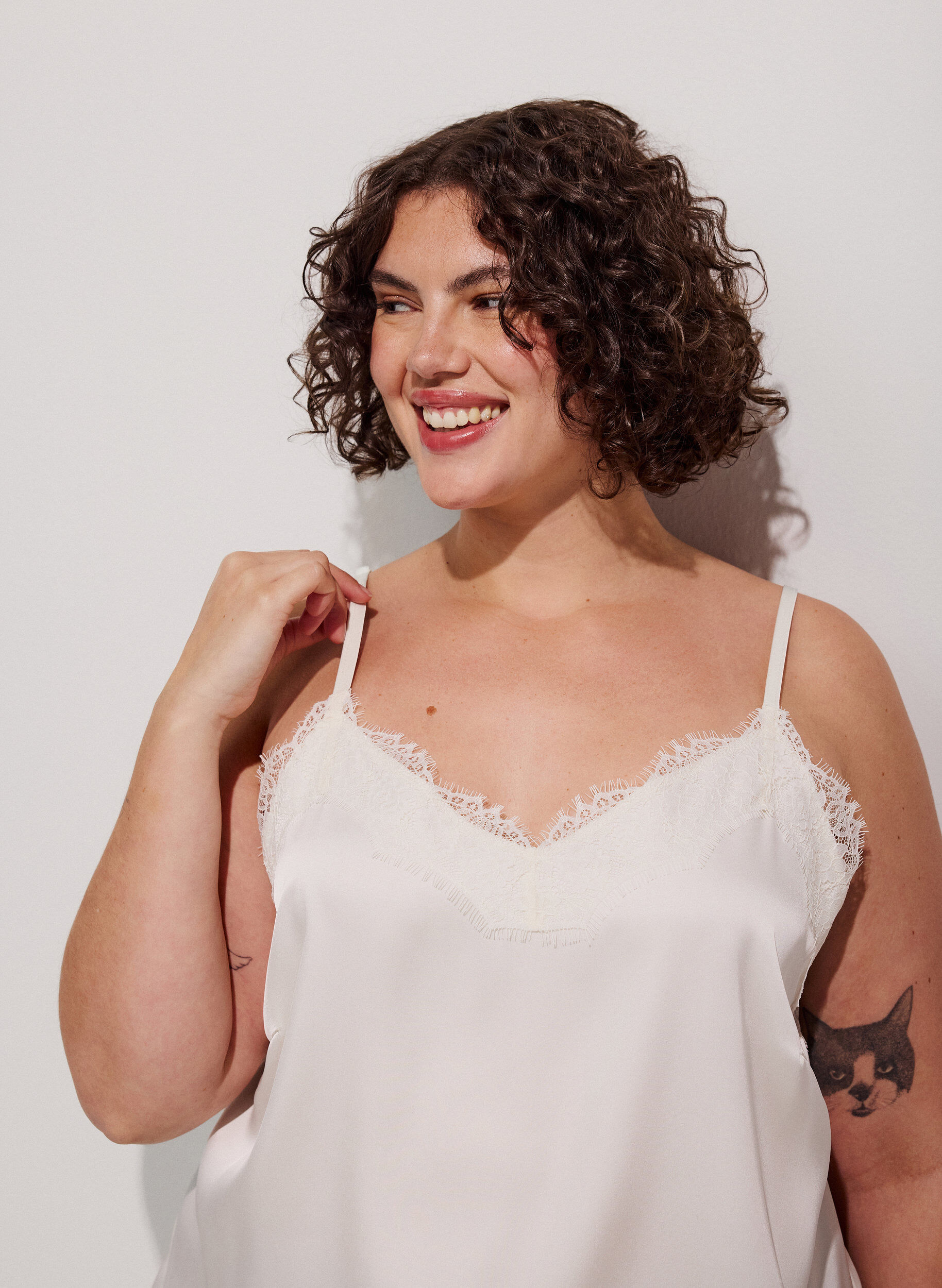 Strappy top with lace and an asymmetrical hem