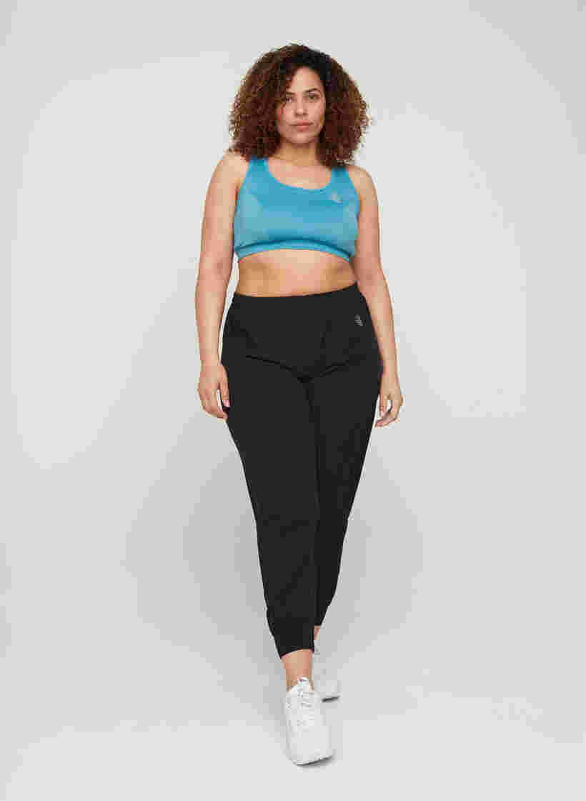 Loose exercise trousers with pockets, Black, Model image number 2