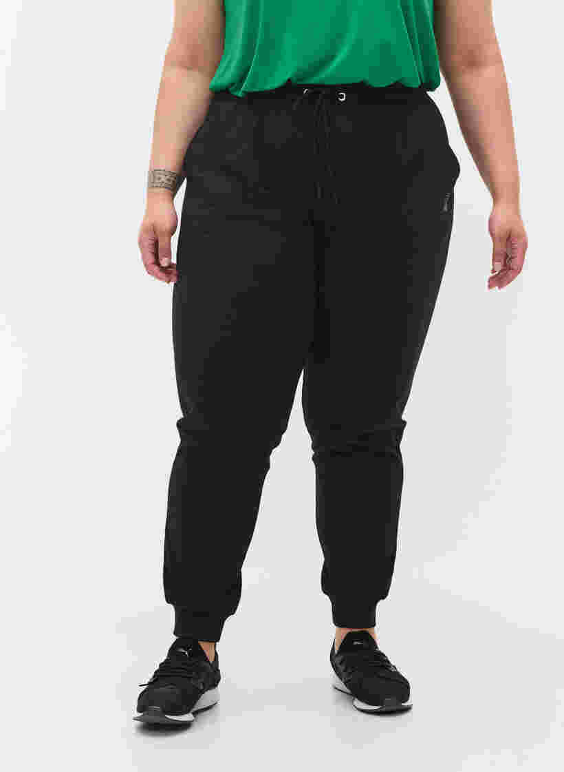 Loose workout trousers with pockets, Black, Model image number 2