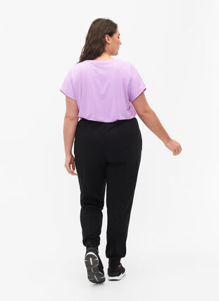 Loose workout trousers with pockets, Black, Model image number 1