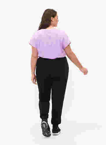Loose workout trousers with pockets, Black, Model image number 1