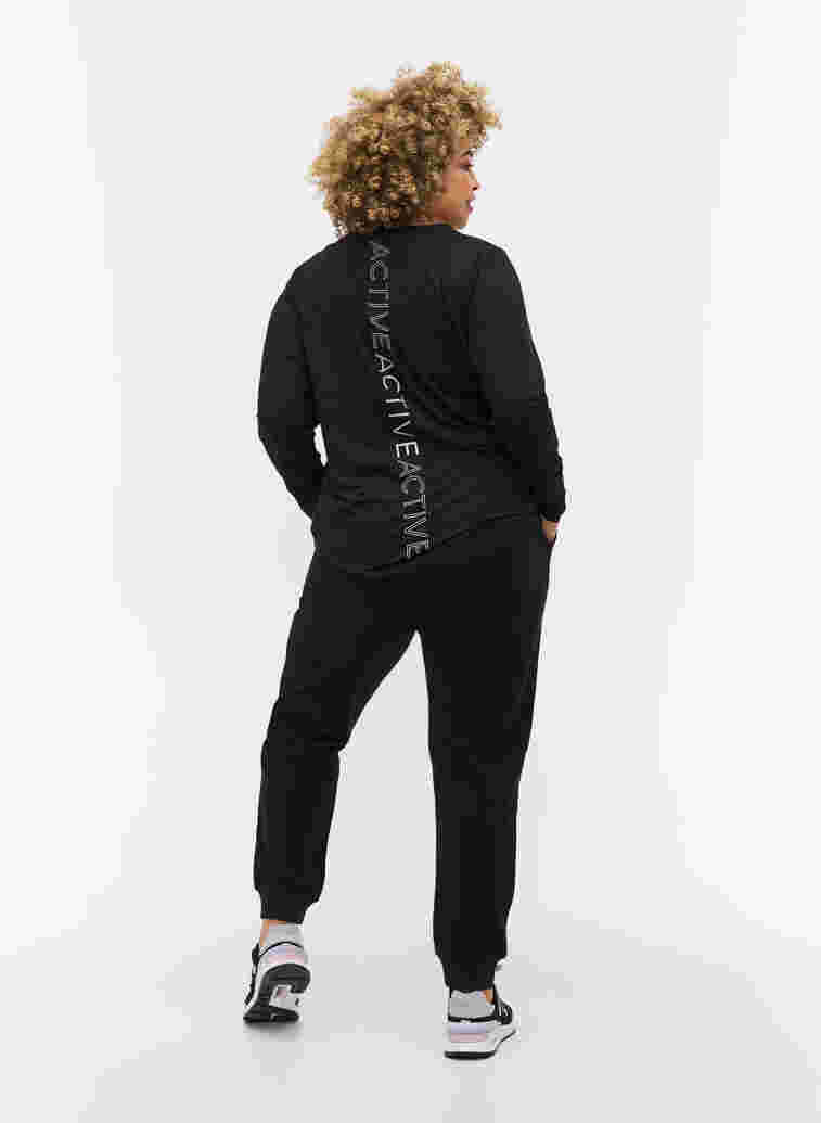 Plain sports pants with pockets, Black, Model image number 1