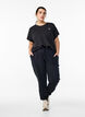 Loose tracksuit trousers with pockets, Black, Model image number 1